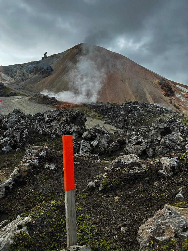 Trail marker with steaming volcano
